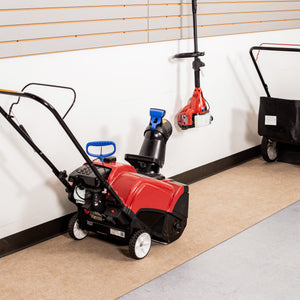 Red and black snowblower on top of Tan Drip & Dry Runner