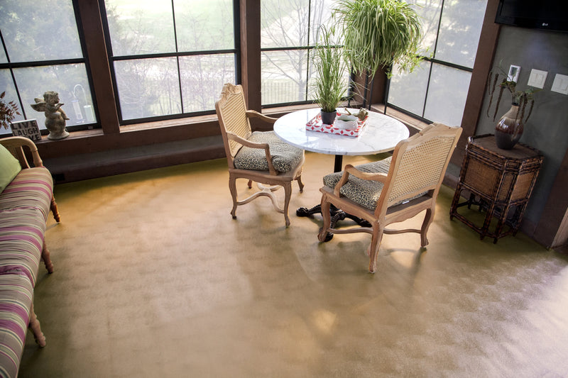 Wall-to-wall installation of Sandstone Levant texture vinyl flooring with table and chairs on top