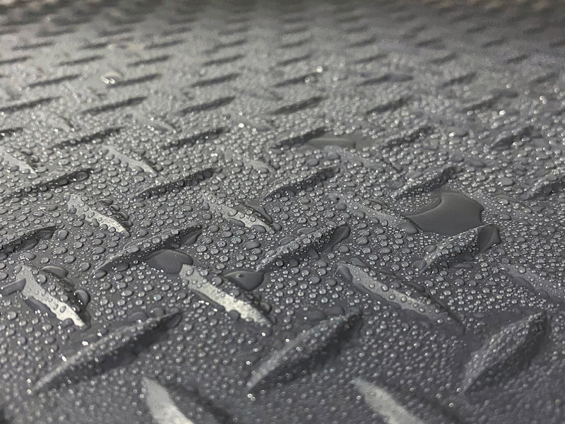 Close-up image of water droplets on Slate Grey Diamond Tread texture vinyl flooring