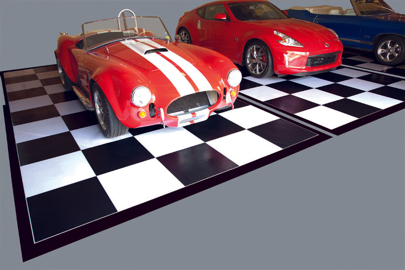 Black and white checkerboard mats shown in garage with cars on the mats for illustrative purposes