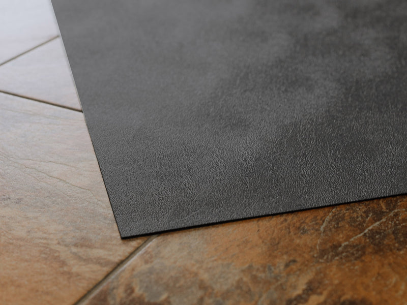 Corner of Slate Grey Levant texture vinyl flooring on top of brown tile floor