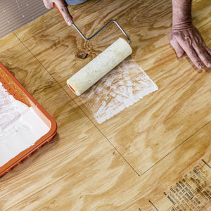 Applying adhesive to wood with paint roller