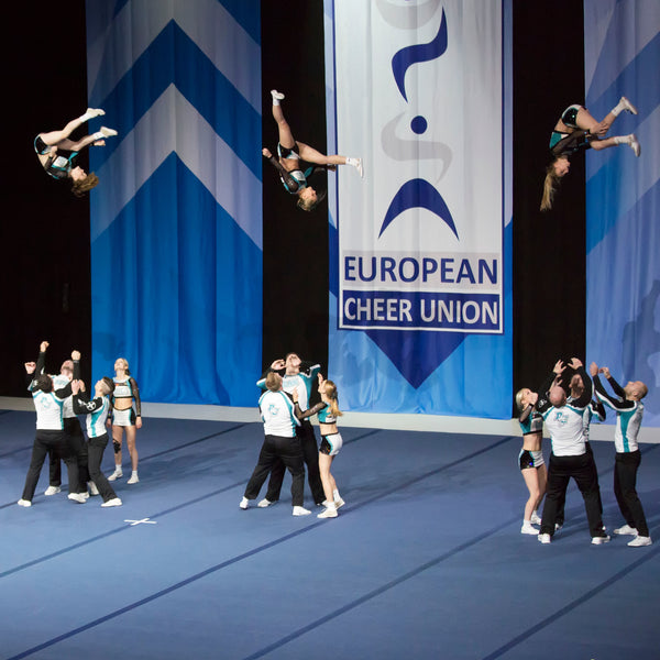 Cheer team performing on carpet bonded foam competition floor