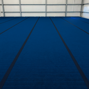 Large carpet bonded foam gymnastics competition floor installed in training facility