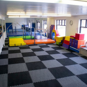 Carpet bonded foam interlocking gym tiles installed in a children's playroom training space