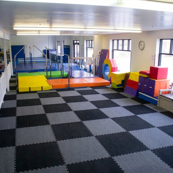 Carpet bonded foam interlocking gym tiles installed in a children's playroom training space