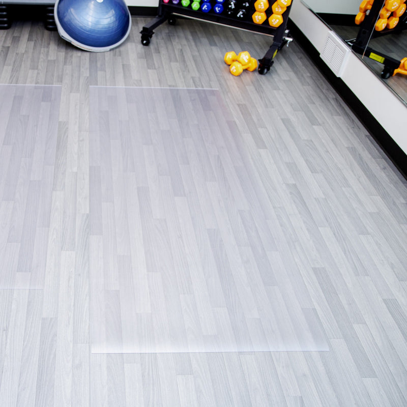 Clear ceramic texture vinyl exercise equipment mat on gray plank flooring