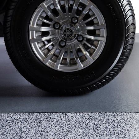 Golf cart tire on Slate Grey Ceramic vinyl golf cart parking pad