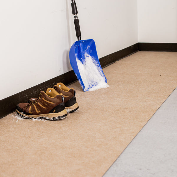 Boots and snow shovel on top of Tan Drip & Dry Absorbent Runner