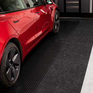 Red car parked on Midnight Black Diamond Tread vinyl flooring with Grey Drip & Dry runner