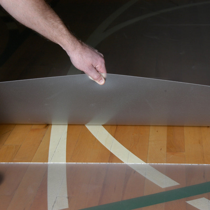 Hand pulling clear vinyl activity flooring