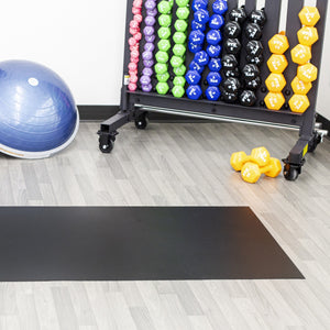 Midnight Black Ceramic texture vinyl floor mat in front of colorful hand weights