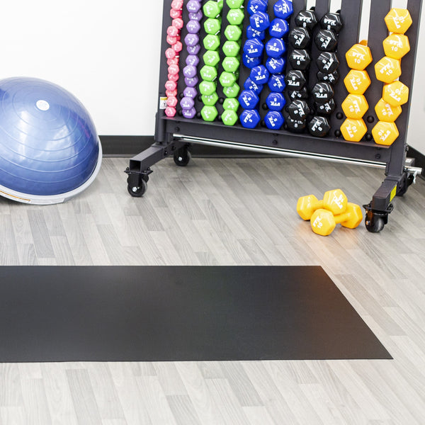 Midnight Black Ceramic texture vinyl floor mat in front of colorful hand weights