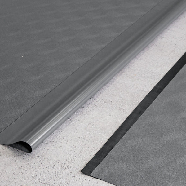 Two pieces of Slate Grey Levant texture vinyl flooring and black seam tape