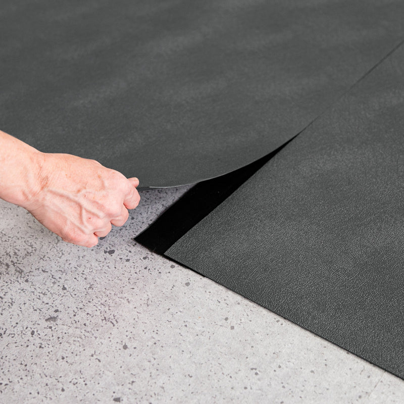 Hand lifting Slate Grey Levant texture vinyl flooring and black seam tape