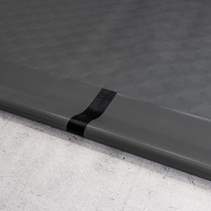 Two pieces of Slate Grey Levant texture vinyl flooring and black seam tape