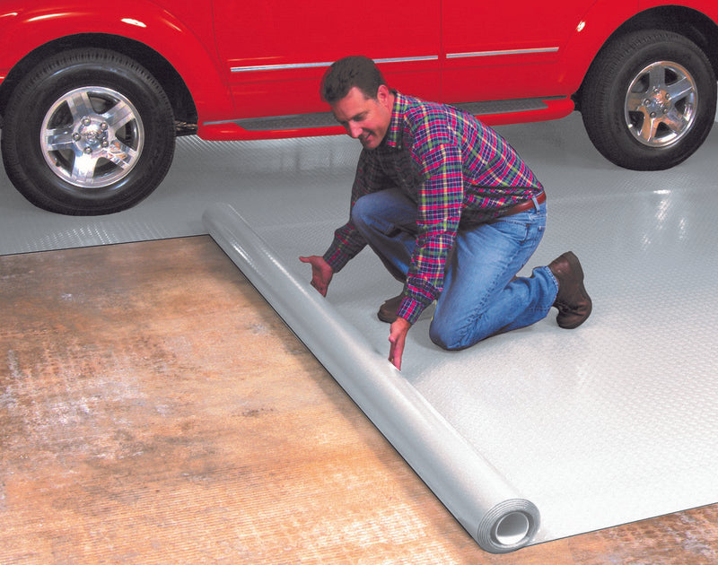 Man kneeling on top of Slate Grey Diamond Tread vinyl flooring