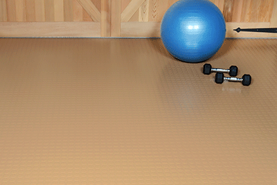 Large Coin texture in sandstone color with a fitness ball and hand weights shown on top of the mat to show a use case scenario
