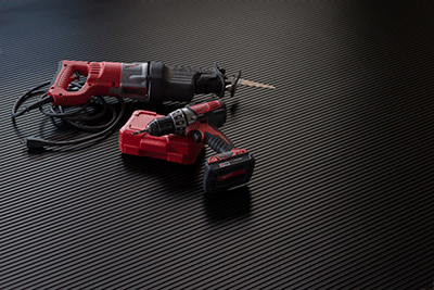 Ribbed texture garage mat in midnight black shown with power tools on the mat for illustrative purposes