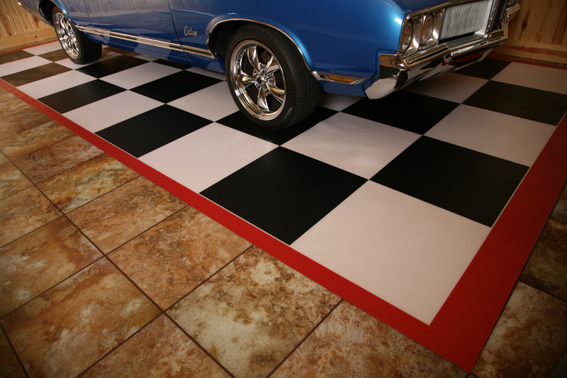 Black and white checkerboard imaged mat with red border shown with a classic blue sports car for a usage example