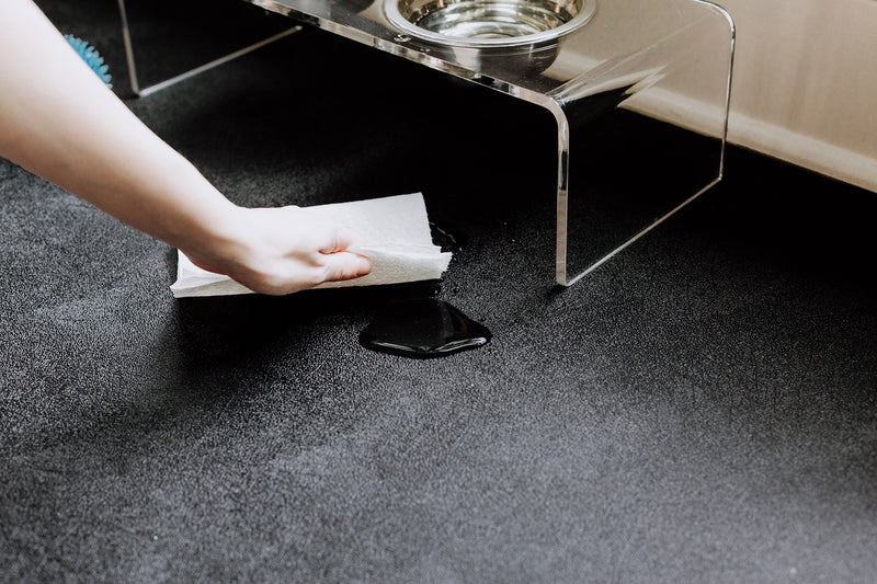 Hand wiping water on Midnight Black Levant texture vinyl pet flooring