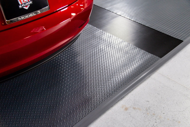 Red car on Slate Grey Diamond Tread texture vinyl flooring with Midnight Black Ribbed texture runner and gray edge trim
