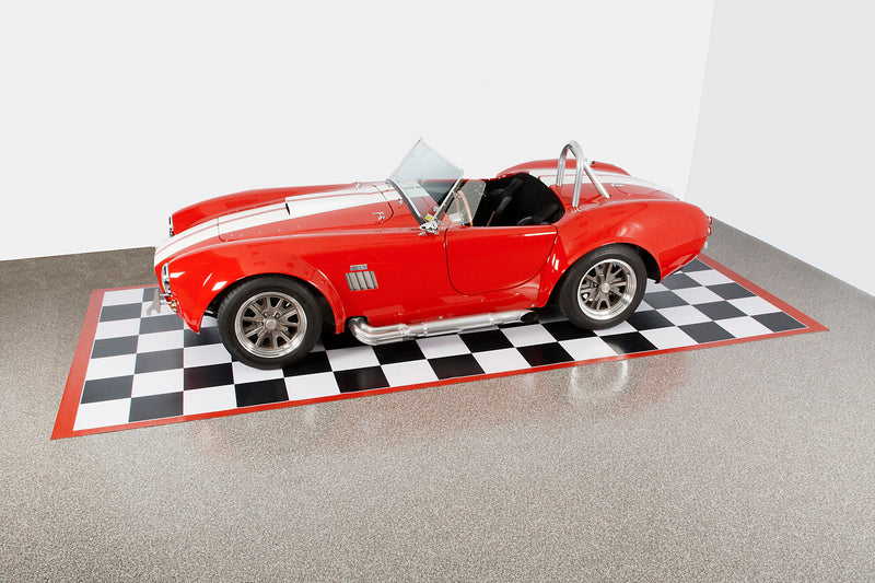 Black and white checkerboard mat with red border showing the whole mat with a red sports car on the mat as an example