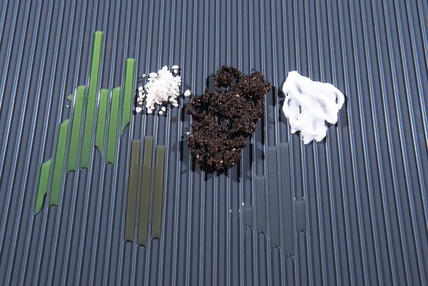 Ribbed texture in slate grey shown with chemicals (dirt, antifreeze, oil, road salt) to show resistance and containment