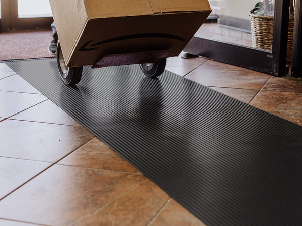 Cardboard box and dolly on Midnight Black Ribbed texture vinyl floor runner