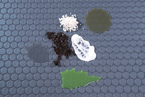 Various chemicals on Slate Grey Small Coin texture vinyl flooring