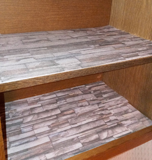 Stacked stone printed shelf liner installed on shelves