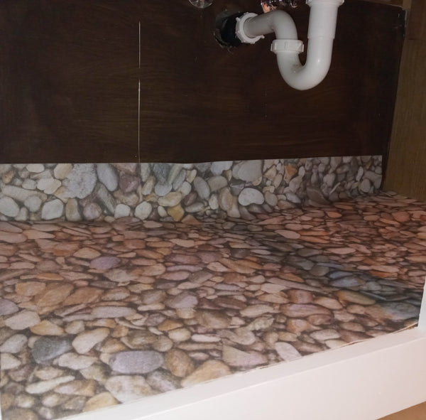 River rock pattern sink liner underneath sink
