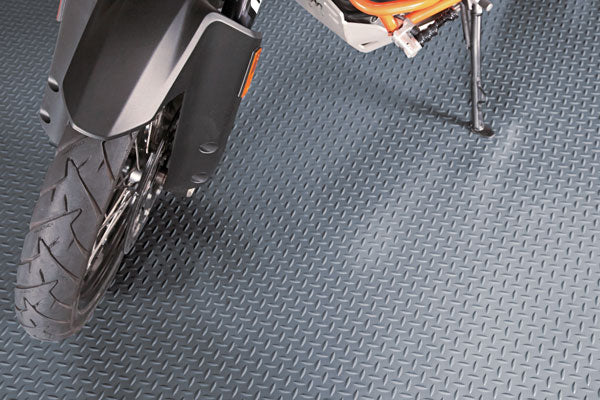Diamond Tread pattern shown in Slate Grey partial view of the mat shown with a motorcycle on the mat