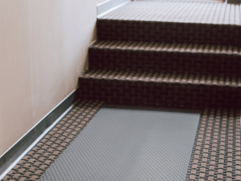 Slate Grey Small Coin texture vinyl floor runner on brown carpet